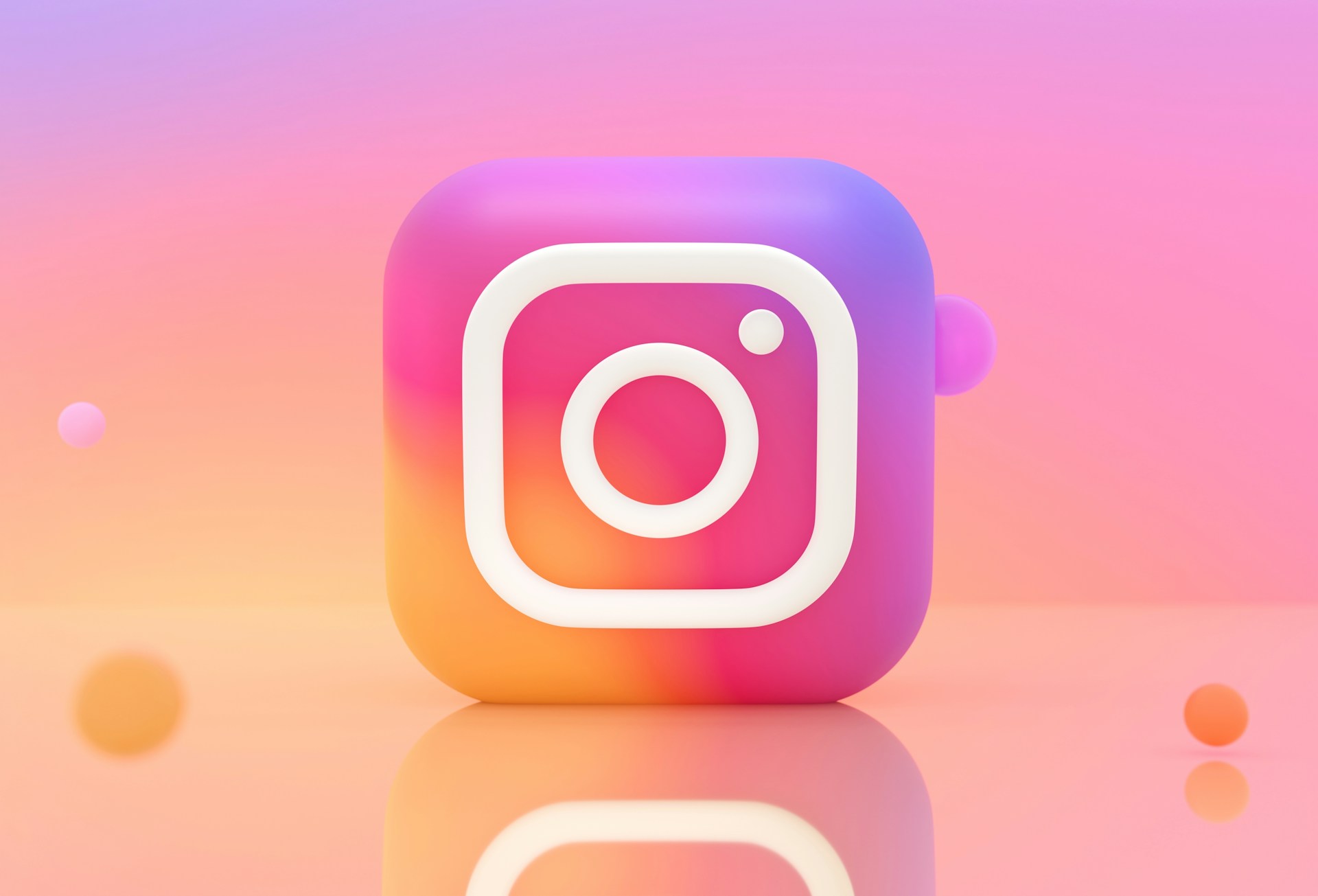 Instagram app icon with colorful gradient on pink and orange background