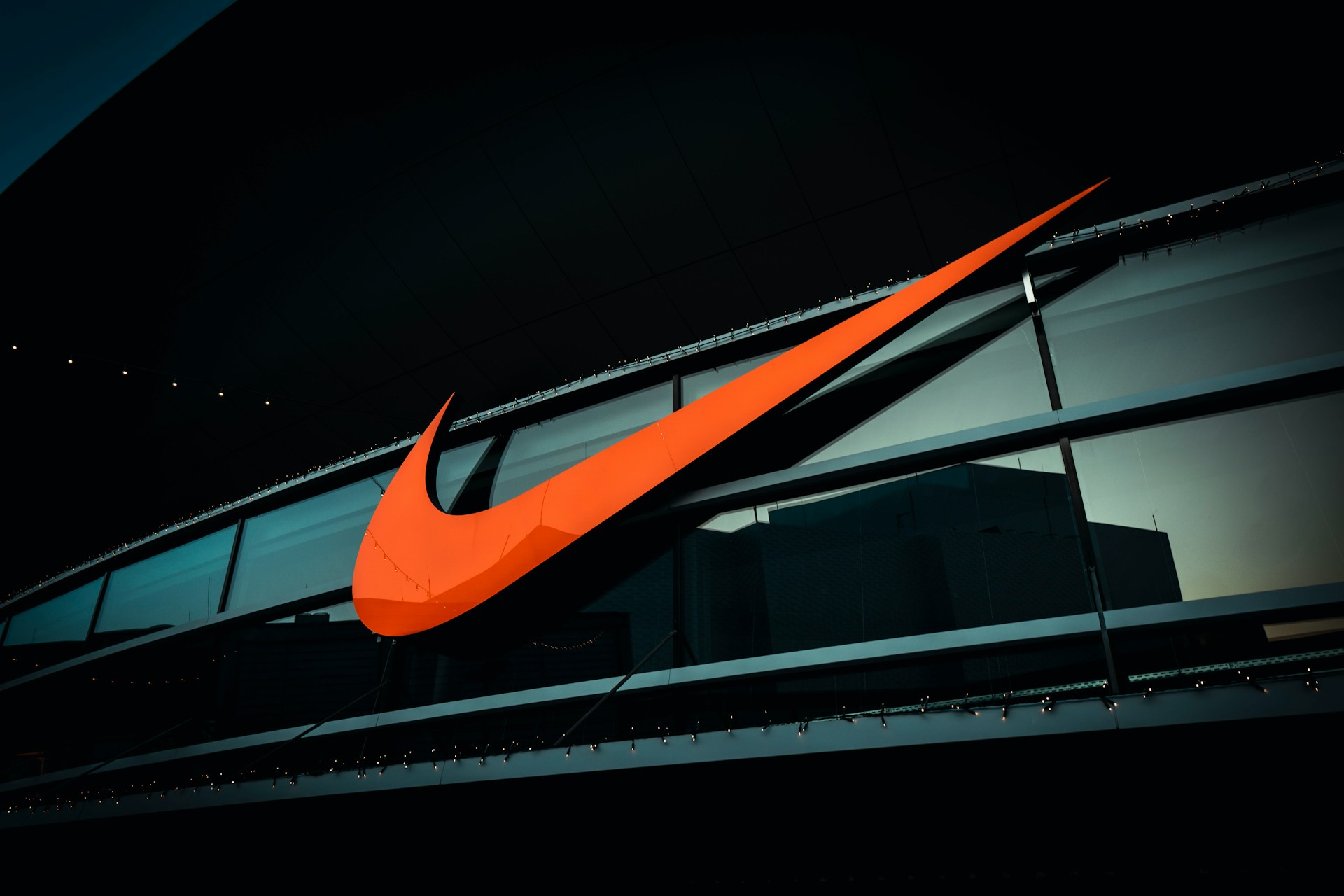 Large orange Nike logo on building